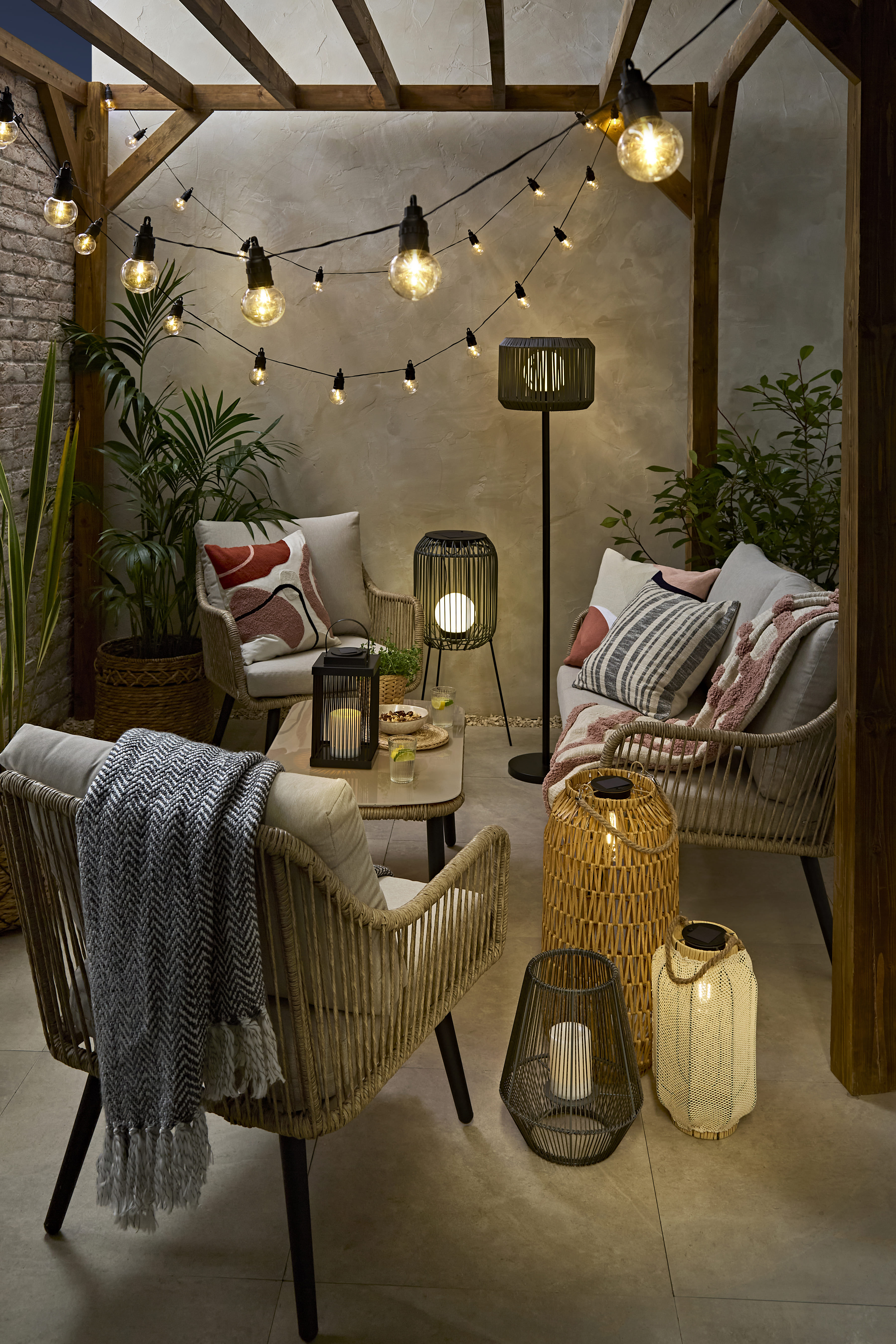 Rattan outdoor lifestyle setting, night-time with warm lighting