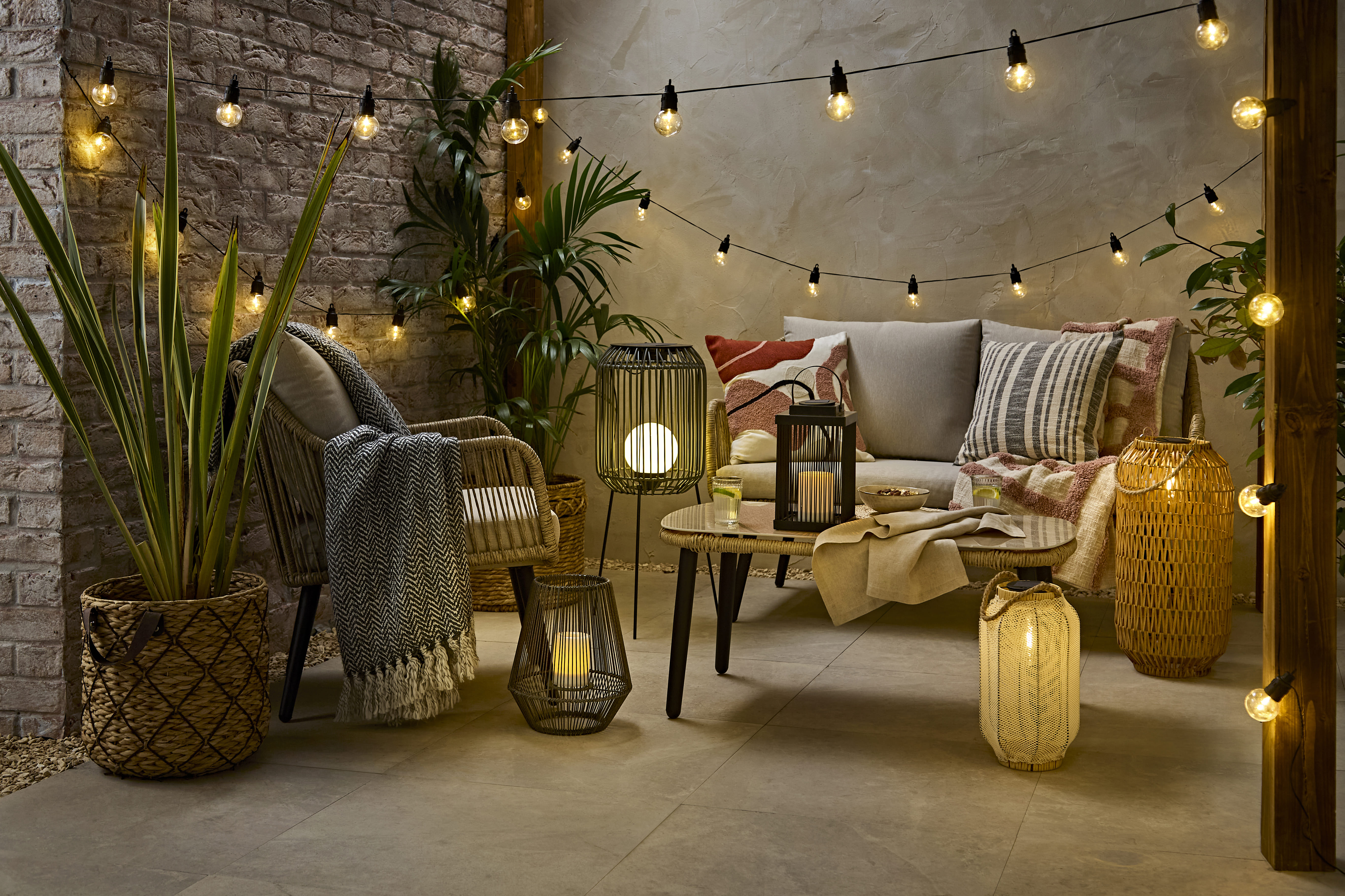 Rattan outdoor lifestyle panorama, night-time with warm lighting
